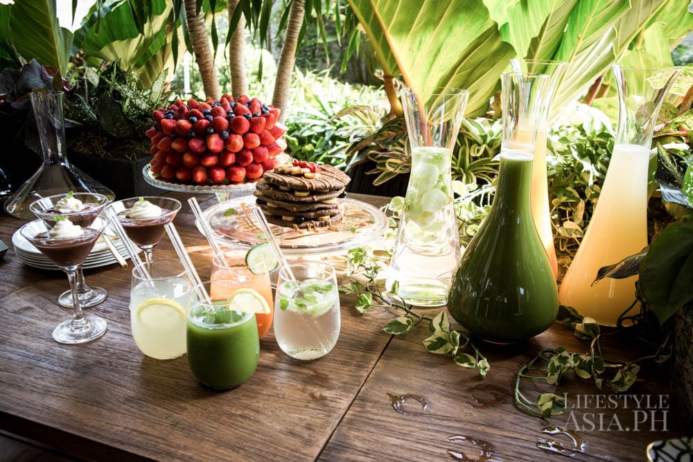 More indulgent desserts are laid out on a table in the lanai along with fruit juices and Aivee Café's famous Holy Kale