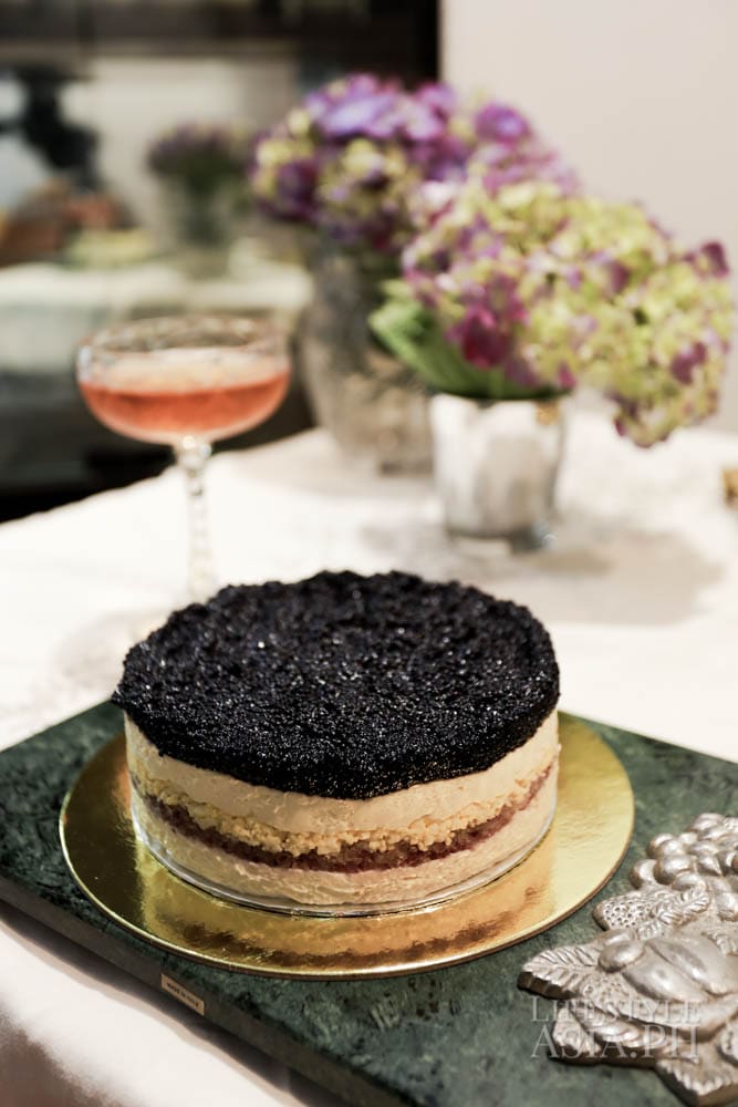 Caviar pie served on a marble tray with sterling silver hand carved with details