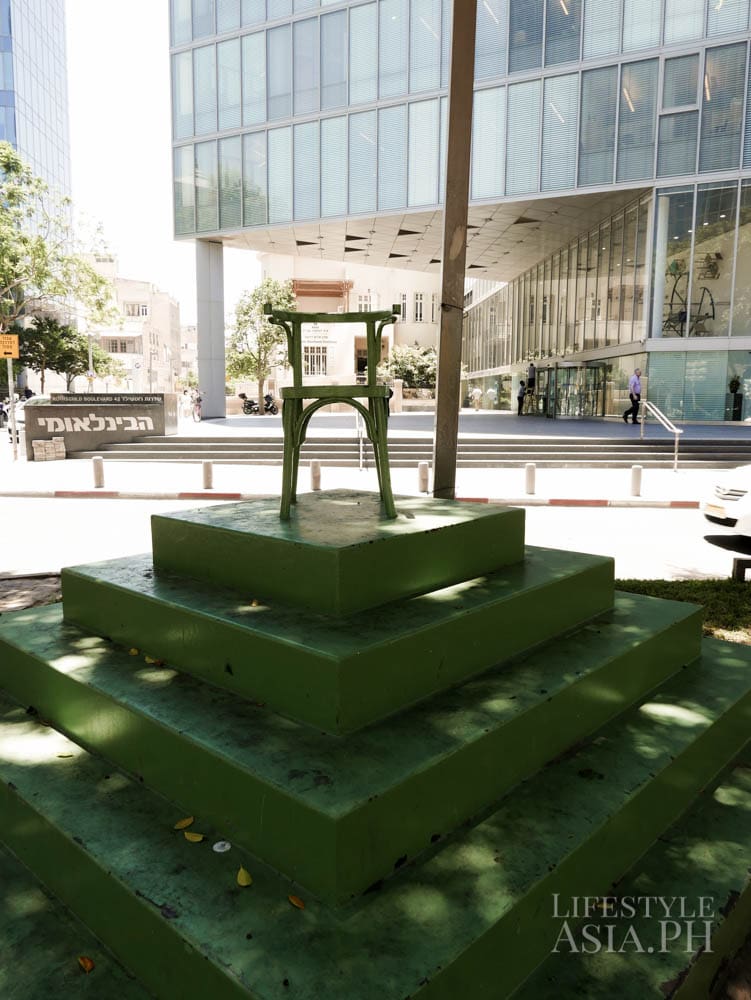 A green chair, set up up along Rothchild Avenue, is part of an art installation from which to see different perspectives from this point of view