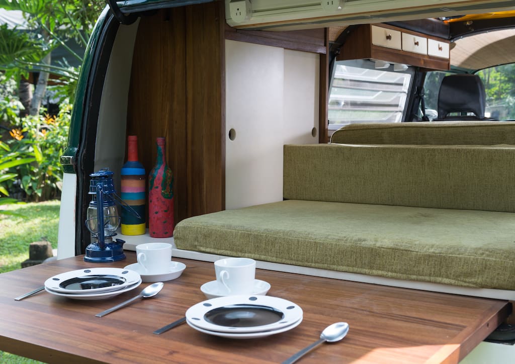 Sustainably grown Acacia wood and green upholstery make up the interiors