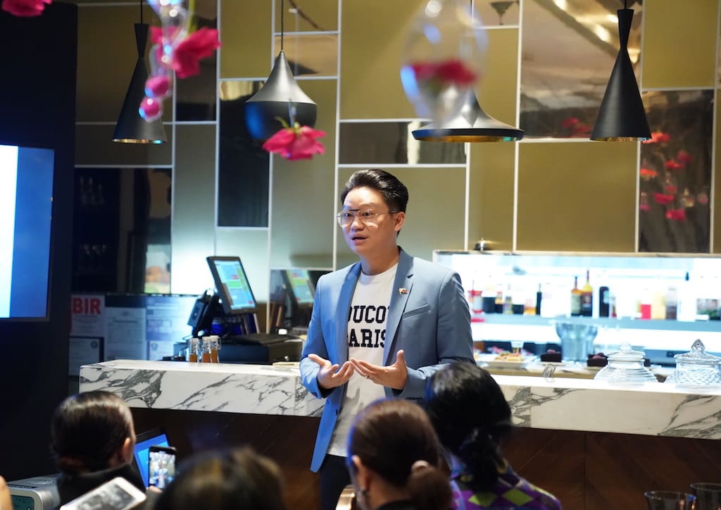 Dr. Z Teo welcoming guests to the preview 