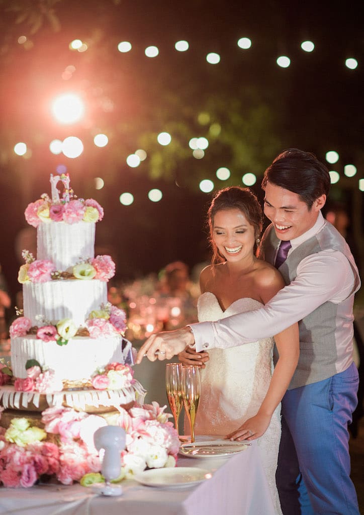The bride and groom slicing their wedding cake