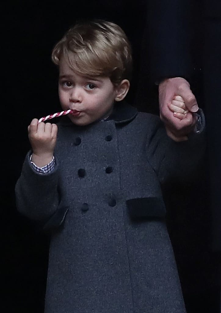 The young prince can make a candy cane matched with a dark grey coat a fashion statement (photograph courtesy of Elle.com)
