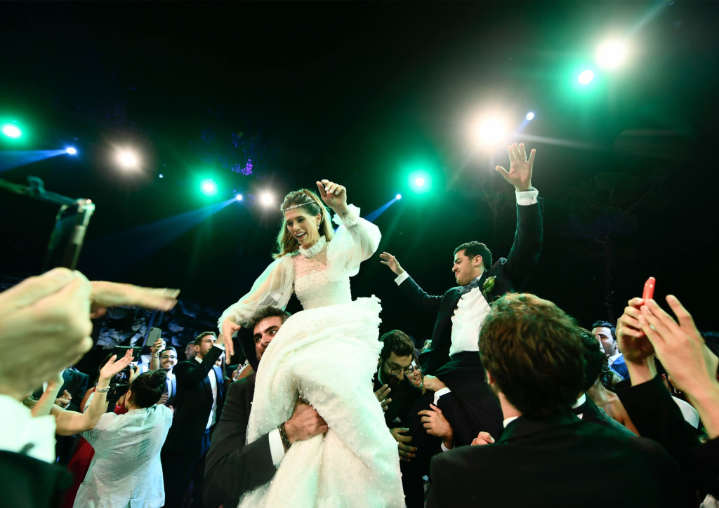 The couple in a traditional dance on the shoulders of their friends (Photograph by Bright Light)
