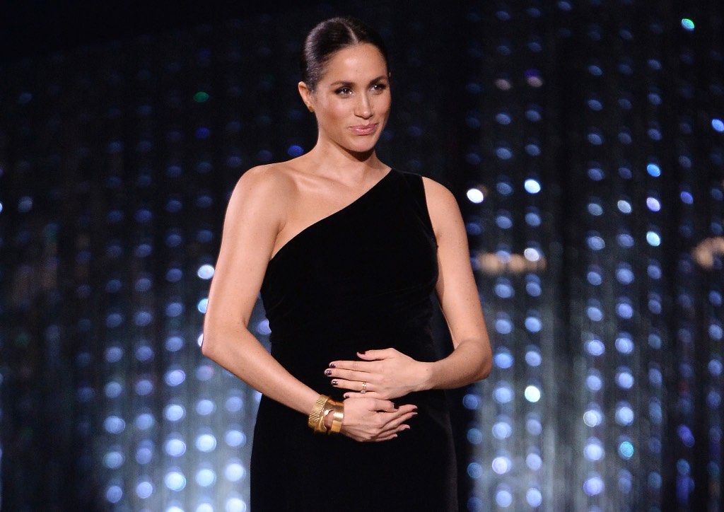 Meghan Markle craddling her baby bump at the British Fashion Awards (Photograph courtesy of People.com)