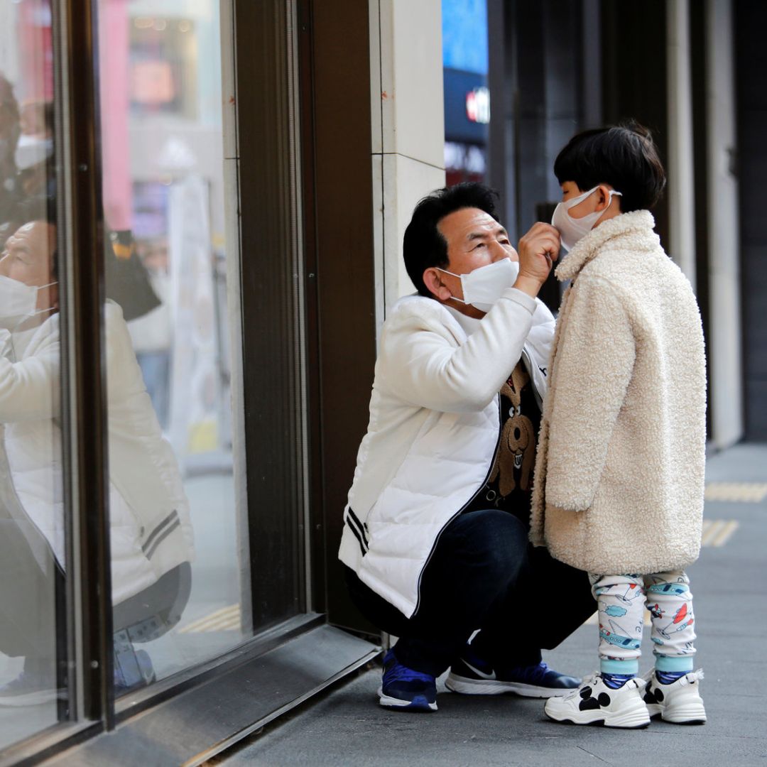 South Korean man and kid wearing mask