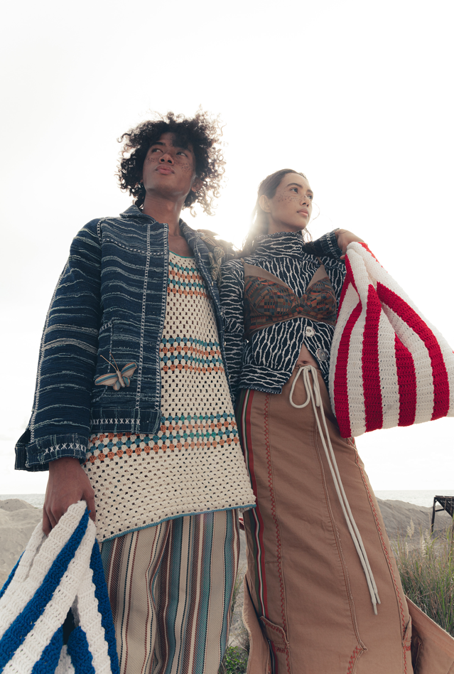 On Jubei (L): Repurposed denim selvage workwear jacket, crochet sleeveless tank top, deadstock upholstery trousers; On Yaofa (R): Shibori print jacquard shrunken jacket, paneled bralette, repurposed twill utilitarian skirt, crochet mini market bags and denim platform sandals, all by JAGGY GLARINO