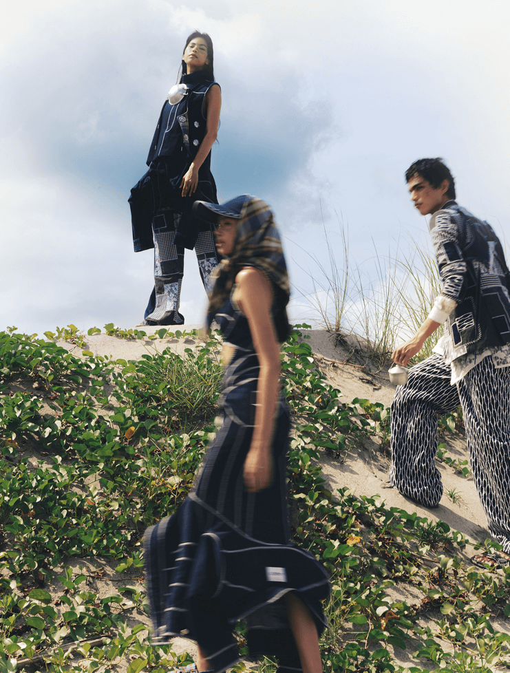 On Yaofa (top): Peek-a-boo denim dress with inverted jacket detail; On Anna (bottom): High neck denim sleeveless top with inverted jacket detail, and patchwork denim collage trousers; On Suraj (rightmost): Patchwork denim suit, cut-off denim apron bib, and shibori print jacquard trousers, all by JAGGY GLARINO