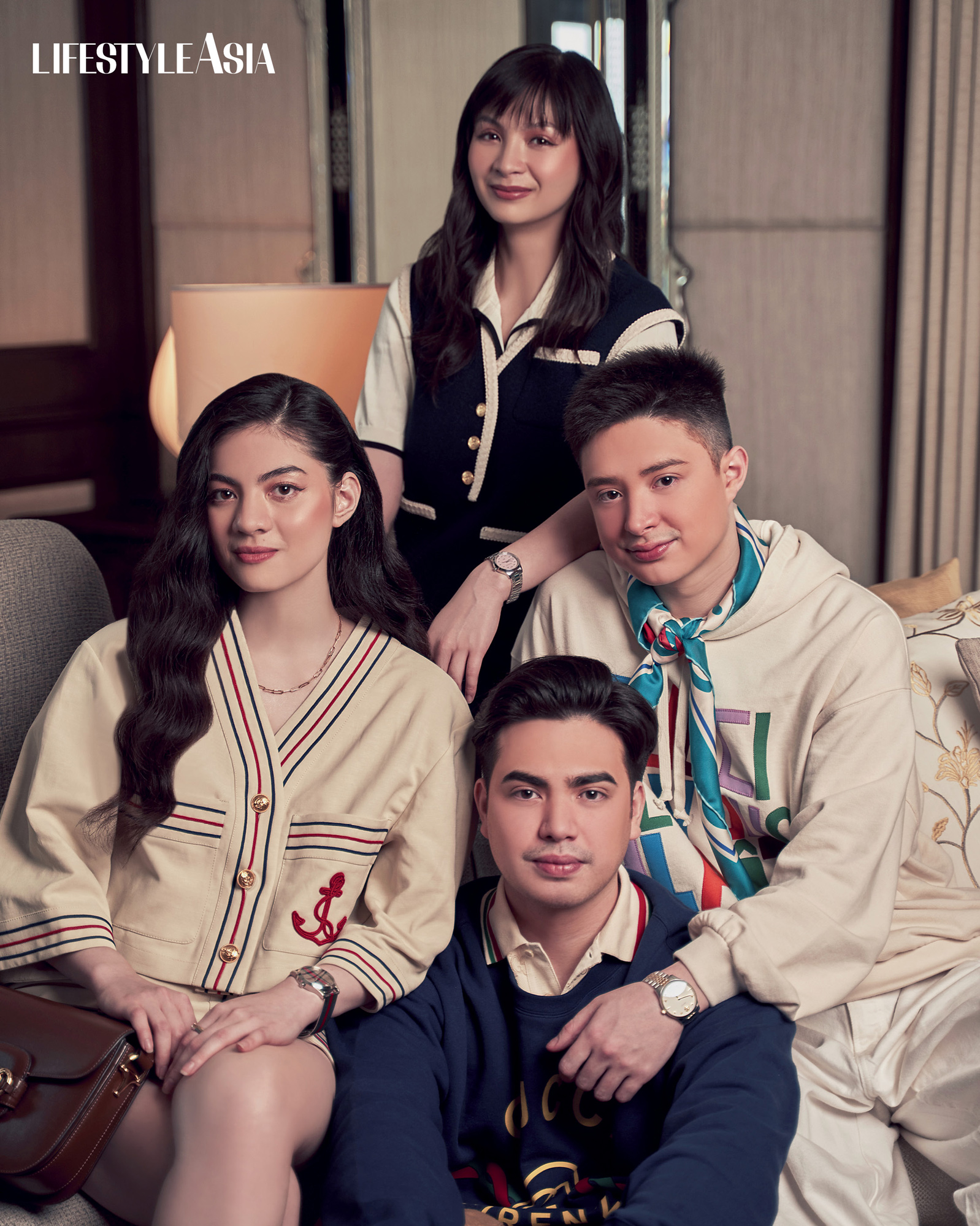 On Julio: Cotton Piquet Polo With GG, Cotton Gucci Firenze 1921 Sweatshirt. On Kerry: Cotton Linen Wrap Shirt And Skirt, Gucci Horsebit 1955 Small Handbag In Brown, Gucci G-timeless Watch in 42mm, Gucci Link To Love Rings and necklace. On Kyle: Retro Tweed Mini Dress and Cotton Cardigan with Interlocking G, and Gucci G-timeless Watch with Bees in 32mm. On Santino: Felted Cotton Sweatshirt With Patch, Washed Organic Denim Pant, Gucci Maxi Flower Print Silk Scarf, and Gucci G-timeless Watch 40mm; all from GUCCI.