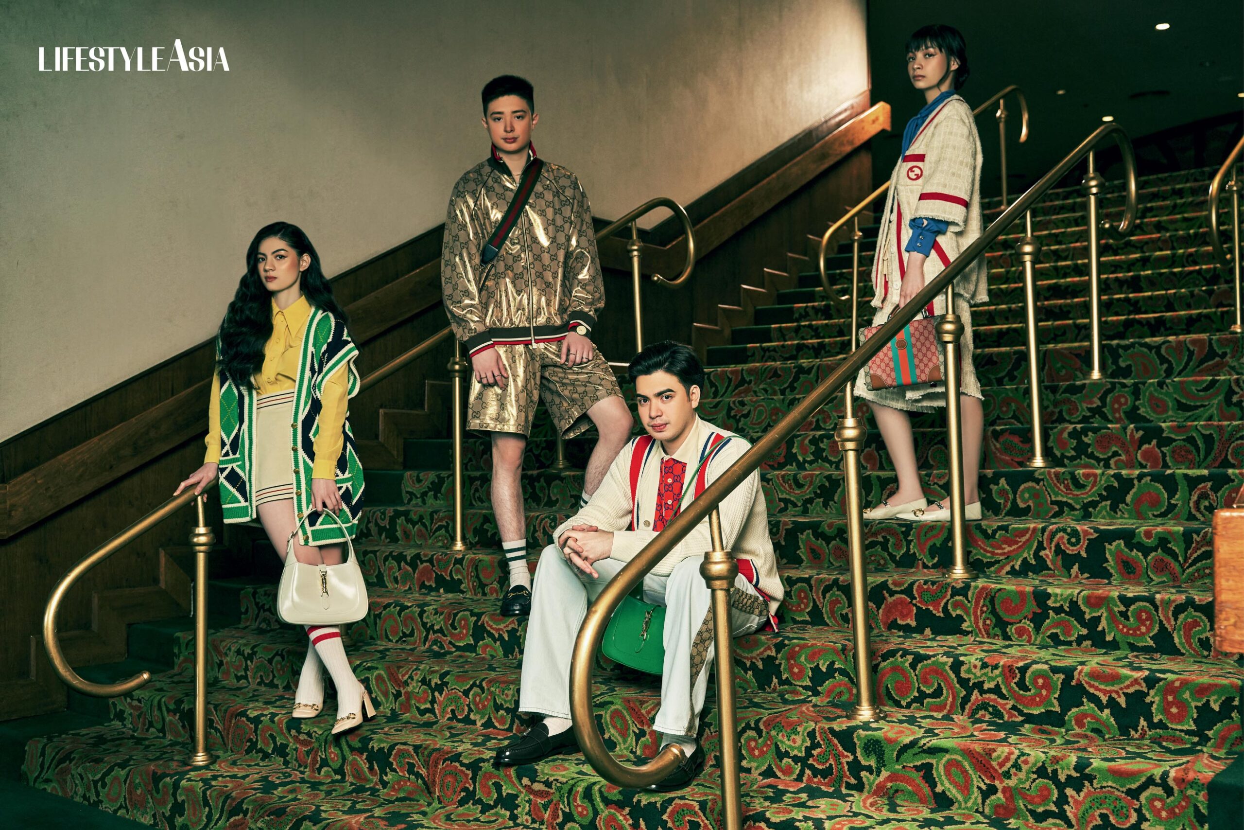 On Kerry: Silk Crepe De Chine Shirt, Cotton Linen Wrap Shirt, G Rhombus Cotton
Stitch Cardigan, Gucci Jackie 1961 Bag With Piston Closure In White, Women’s Mid-heel Slingback with Horsebit. On Santino: GG Technical Jersey Zip Jacket And Basketball Shorts, Men’s 1953 Horsebit Loafer, Gucci Horsebit 1955 Mini In Black, Gucci 25h Watch In 38mm, Gucci Link To Love Rings and Necklace. On Julio: Cotton Piquet Polo With GG, Knit Cotton Cardigan With Patch, Washed Organic Denim Pant, Gucci Jackie 1961 Bag With Piston Closure In Green, Men’s Interlocking G Loafer. On Kyle: Silk Satin Shirt, Cotton Twill Jacket And Shorts With Embroidery, GG Top Handle Beauty Case, And Women’s Horsebit Pump; all from GUCCI.