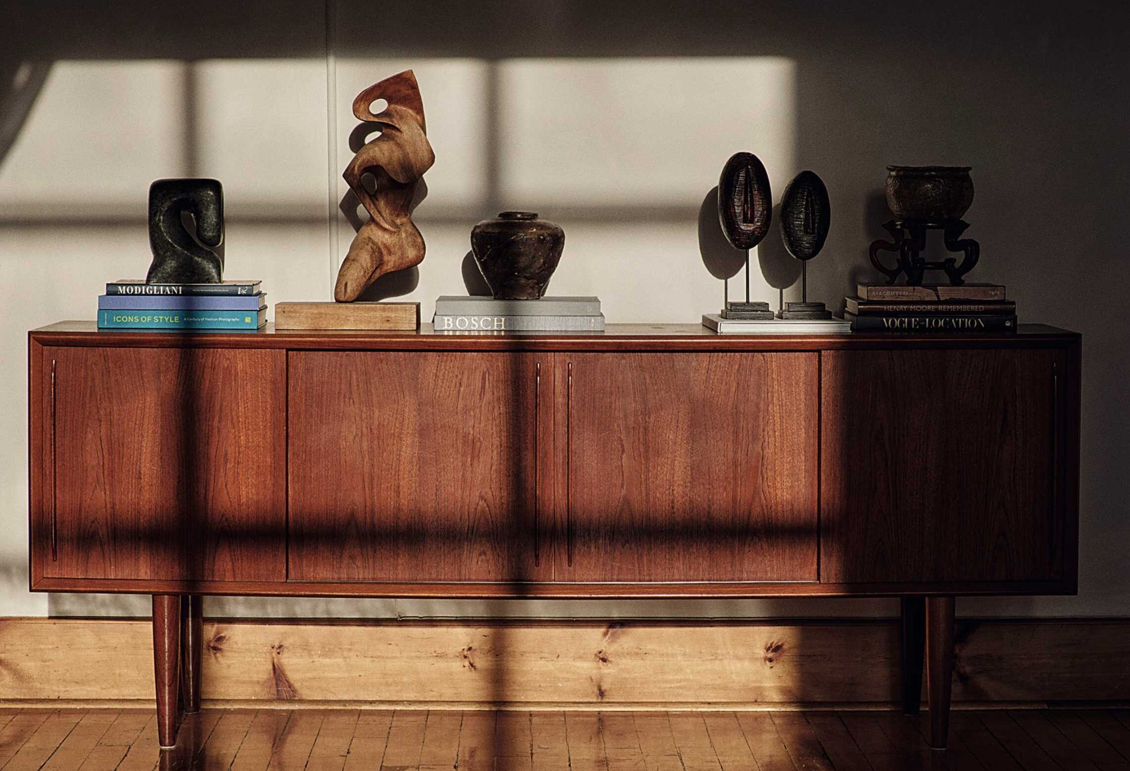 The vintage cabinet was with the original owners for decades before being offered for sale online. Various objects, including the antique vase from Bona's mother, are displayed on top.