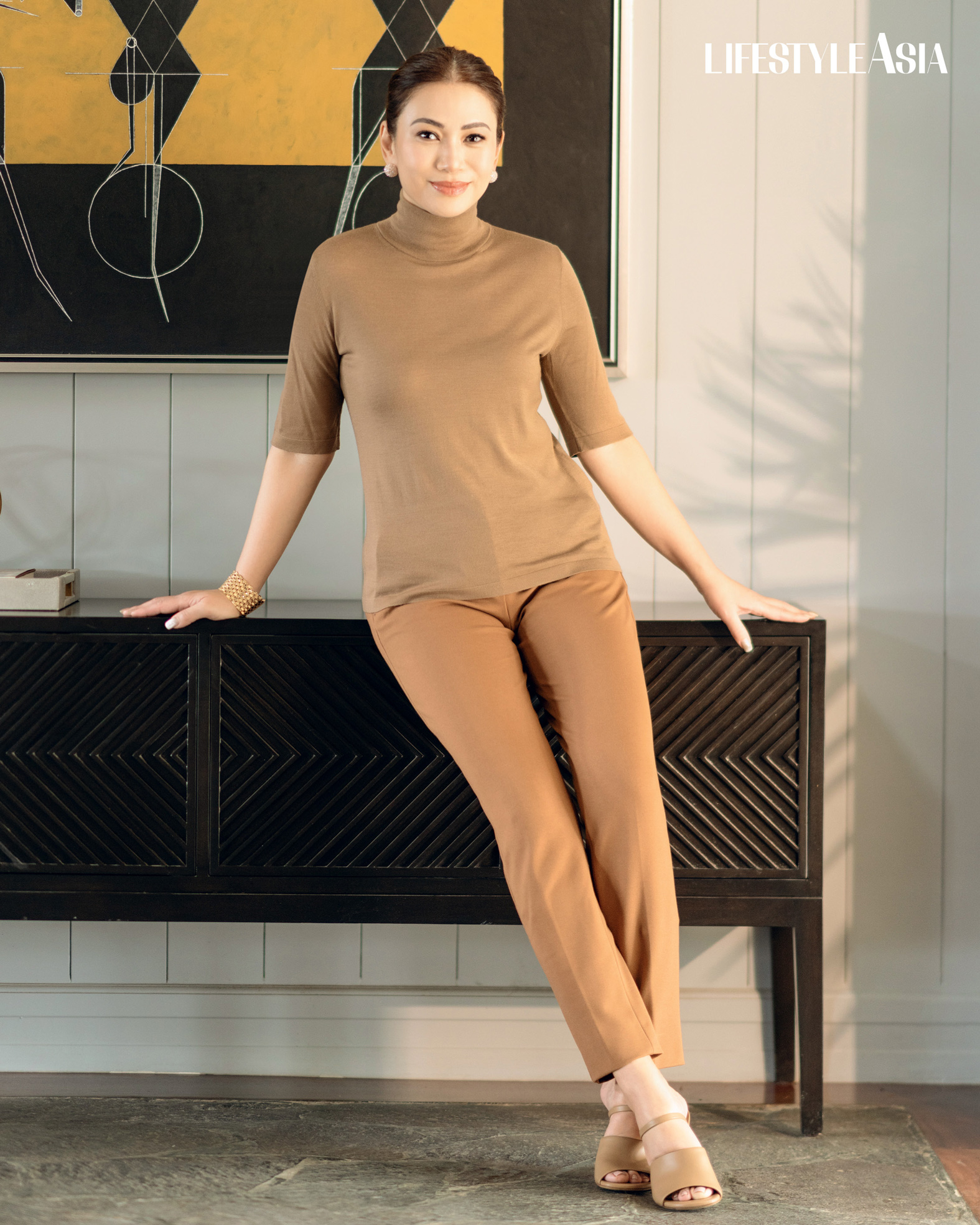 Tan turtleneck cashmere top and trousers, MAX MARA; Tan Fendi First high heeled slides, FENDI; Vintage pave diamond earrings and gold bracelet, JMA JEWELRY.