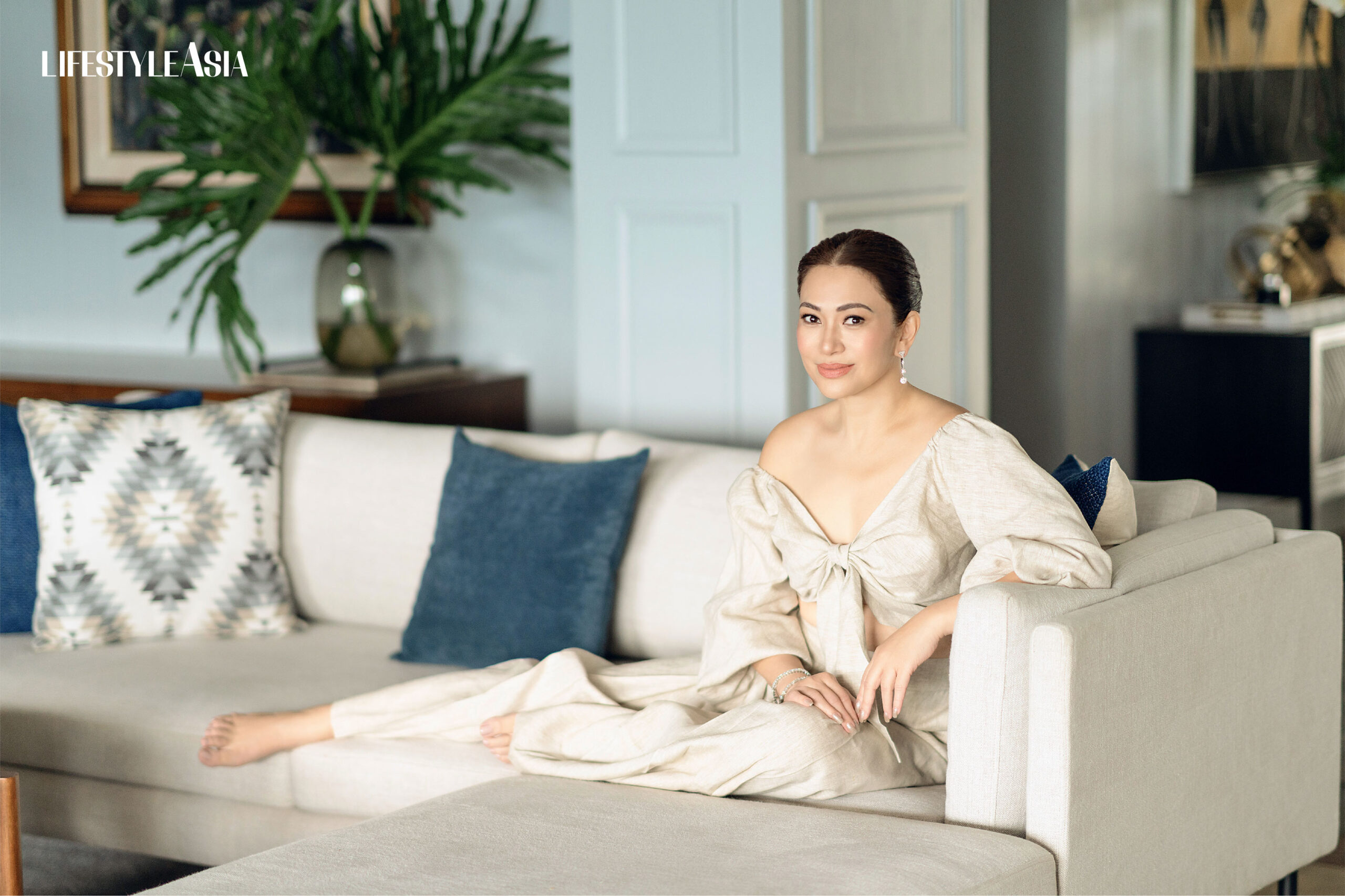 Oatmeal linen off shoulder tie front top and matching pants, TRUDE LIZARES; Asymmetric diamond dangling earrings, JMA JEWELRY.