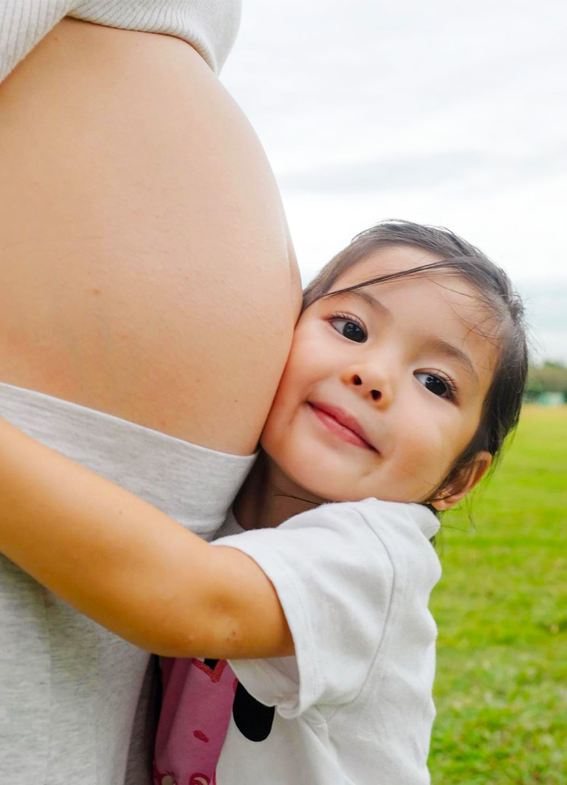 Amelia Manzano-Reyes giving a big hug to her mom Andi's baby bump