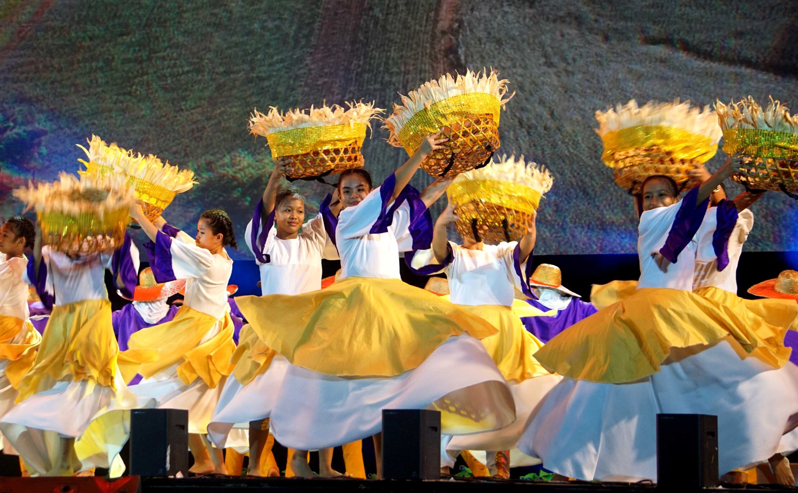 Dancers with costumes and baskets inspired by the corn harvest