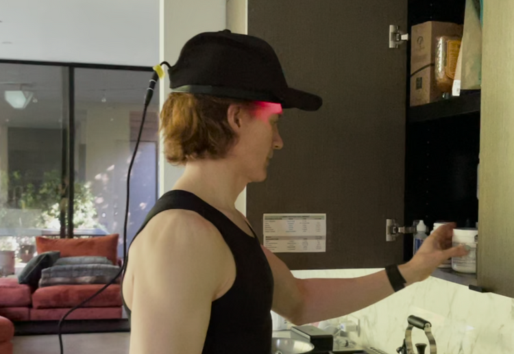 Bryan Johnson wearing a special laser cap