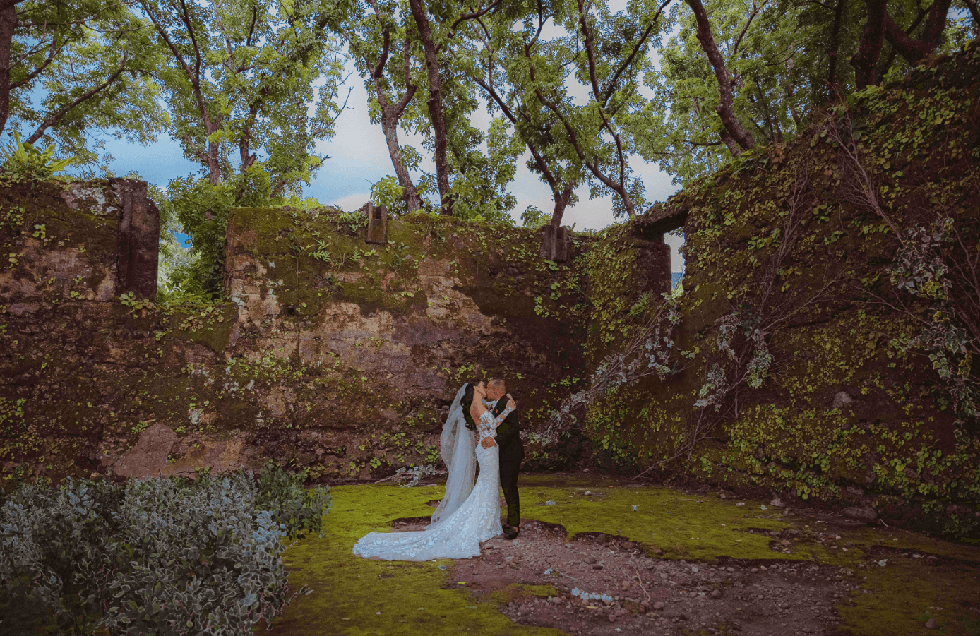 Julien and Patrick share a kiss among the foliage and beautiful ruins of Camiguin