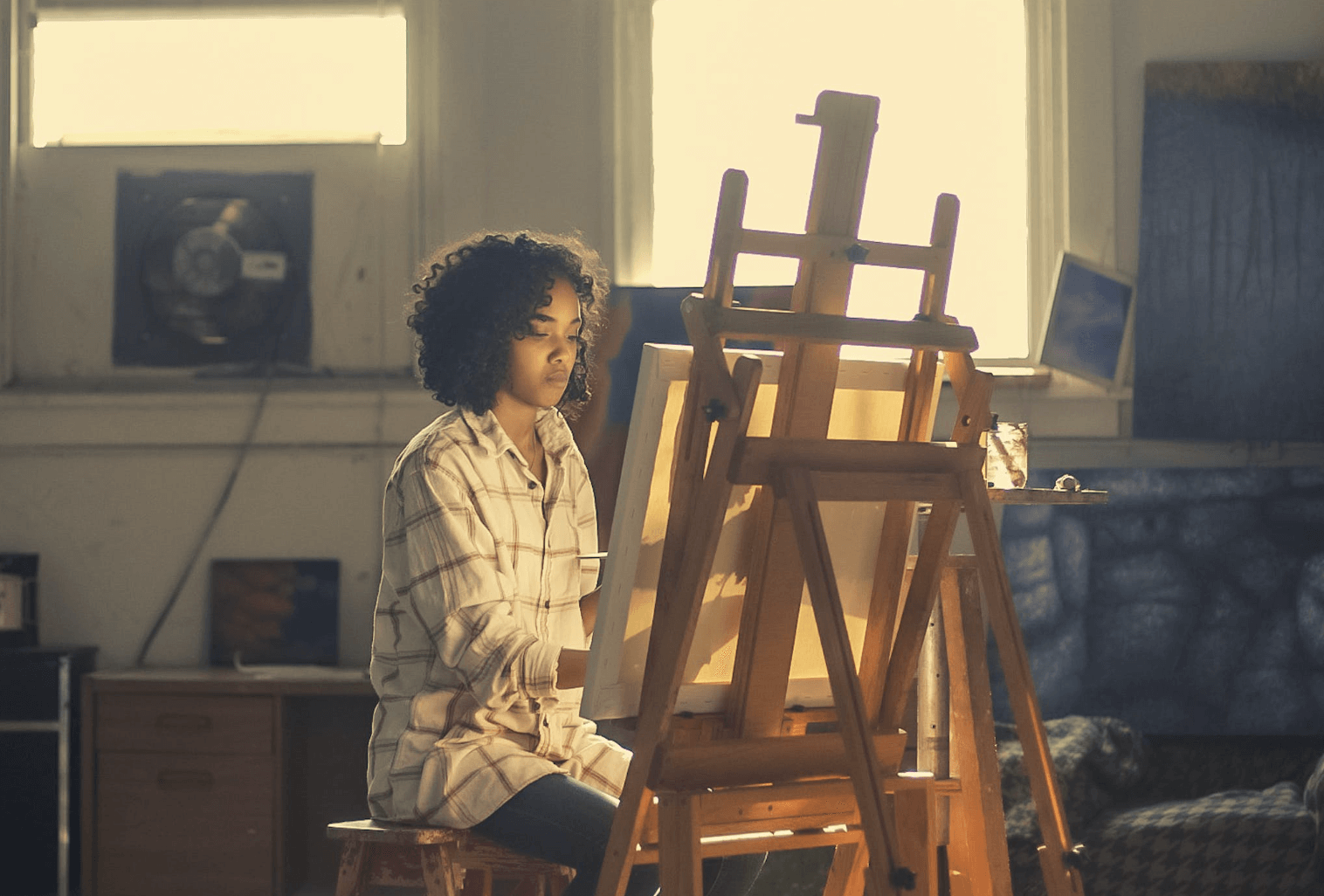 Photo of a woman painting.