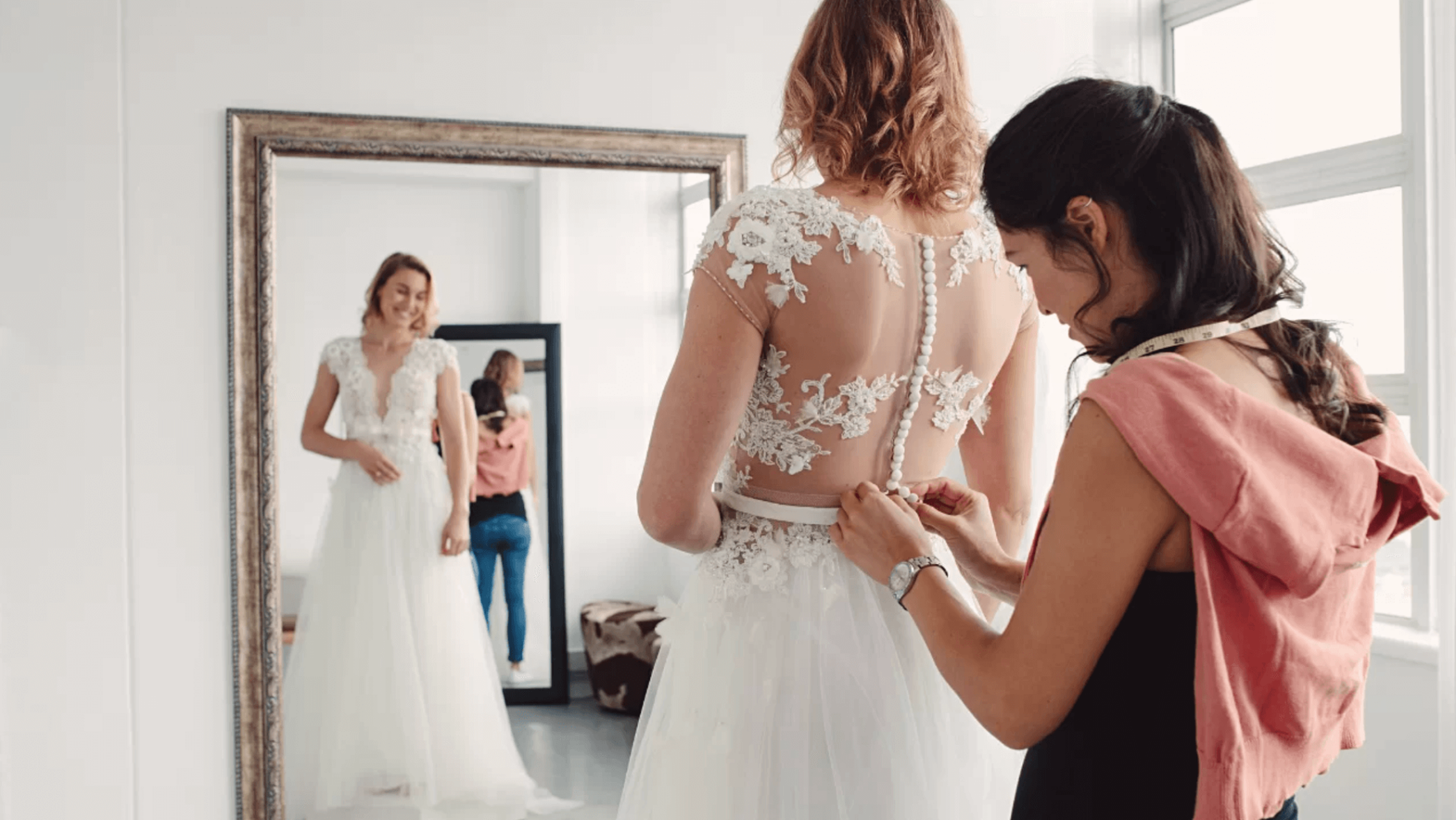A bride fitting her wedding gown