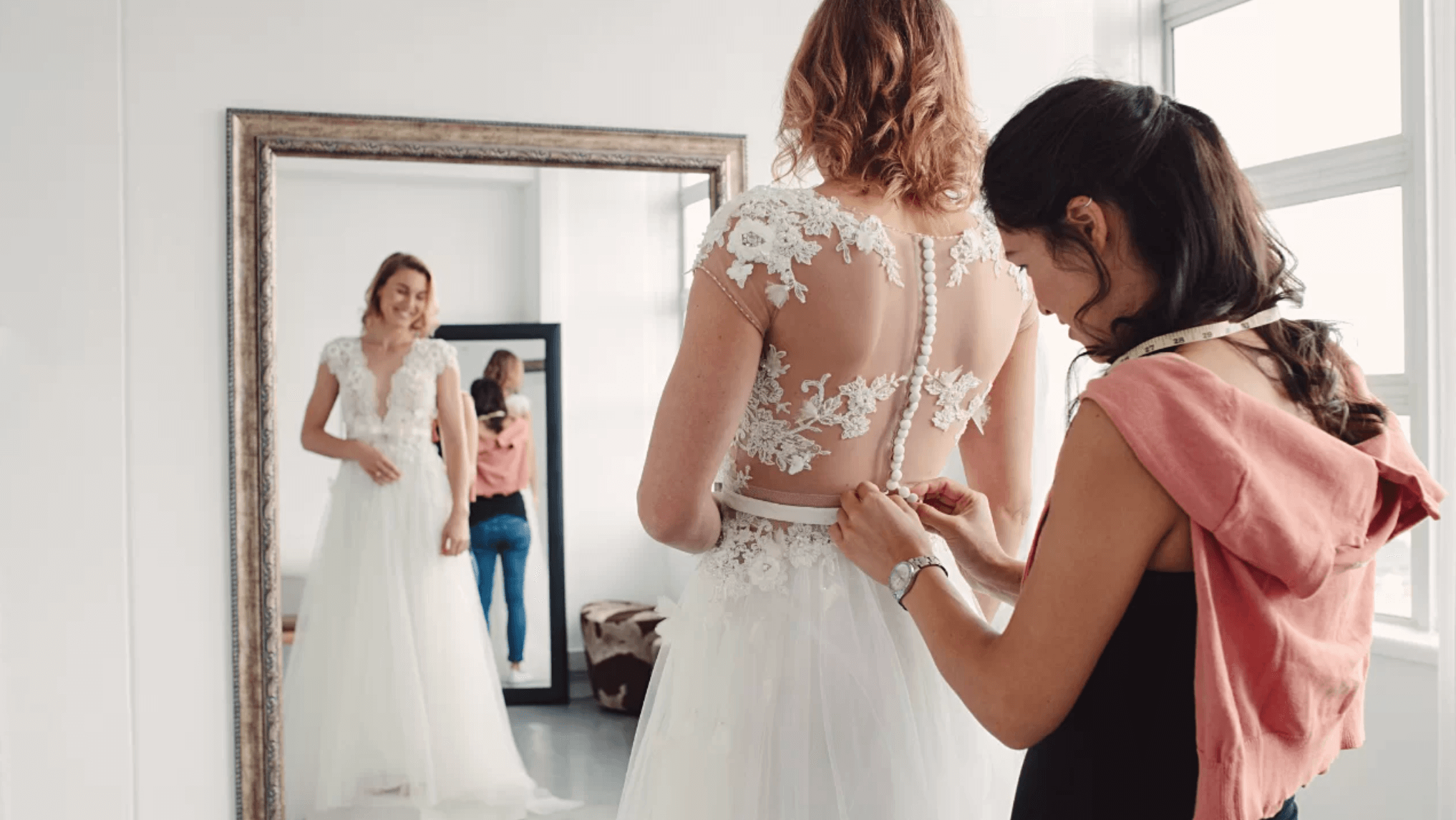 A bride fitting her wedding gown