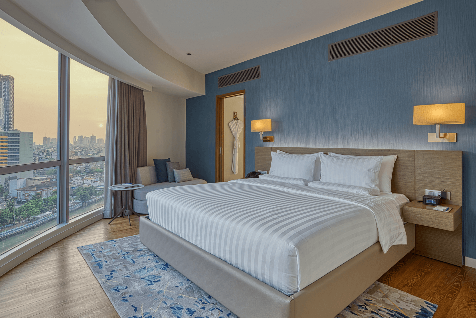 A king bed in a Premier Suite with gorgeous city and river views at Novotel Suites Manila at Acqua