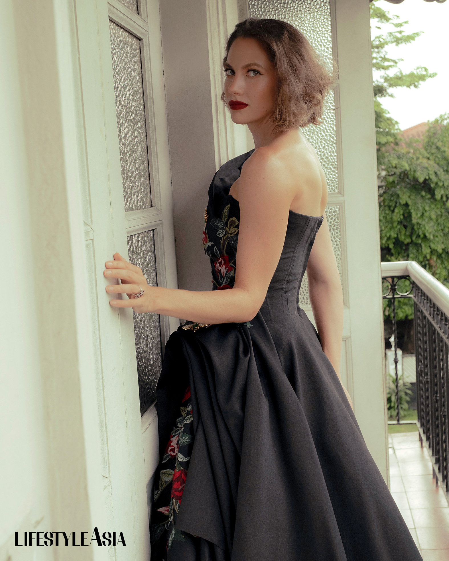 Black silk gazar dress with floral appliques, JO RUBIO; Insect brooches and assorted rings, JUL B DIZON JEWELLERY.