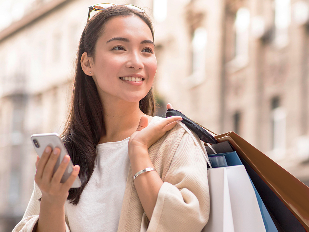 woman with phone and shopping bags 
