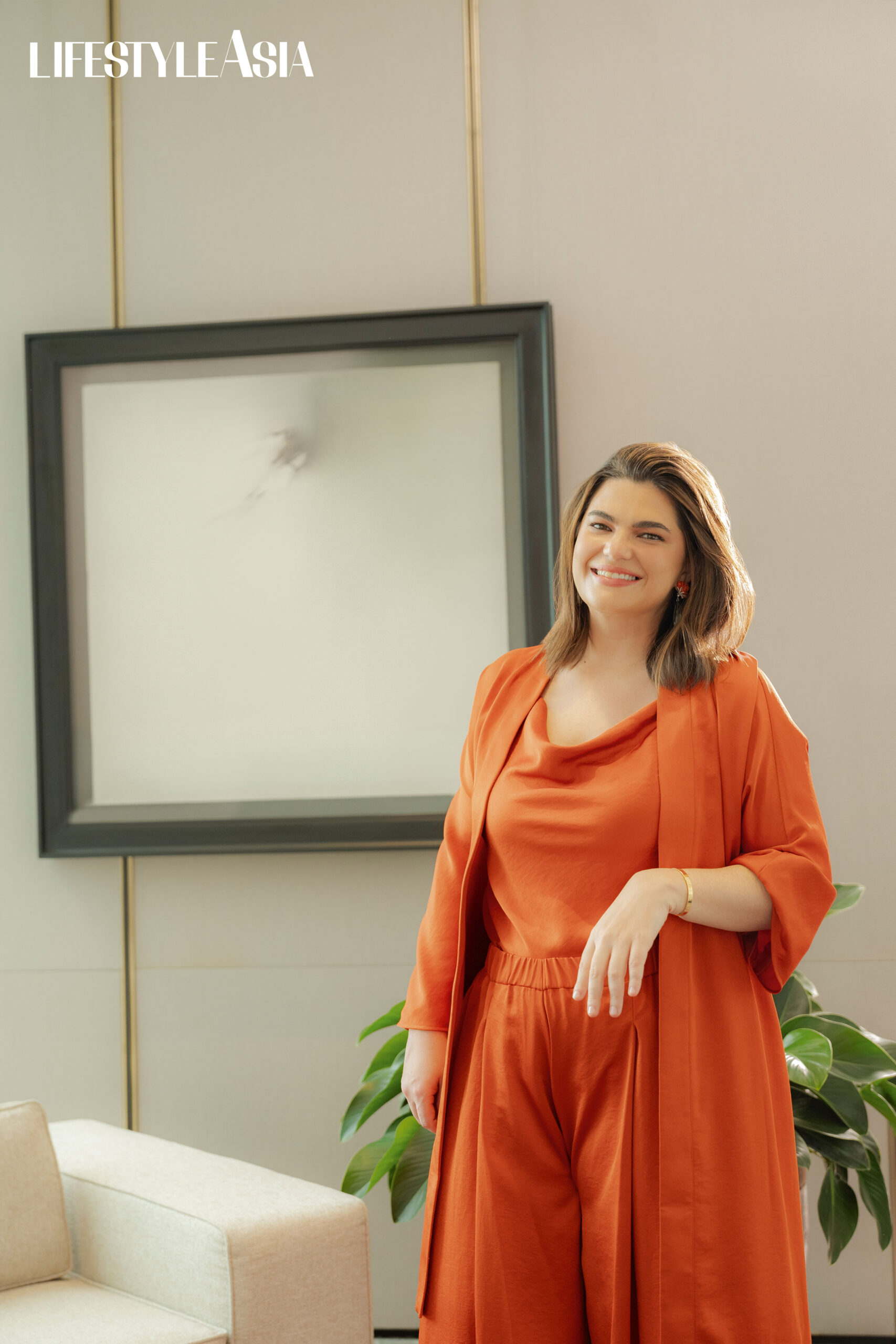 Rust silk robe and cowl neck top, ADOLFO DOMINGUEZ; Pants, ADOLFO DOMINGUEZ; Earrings, JUL B DIZON.