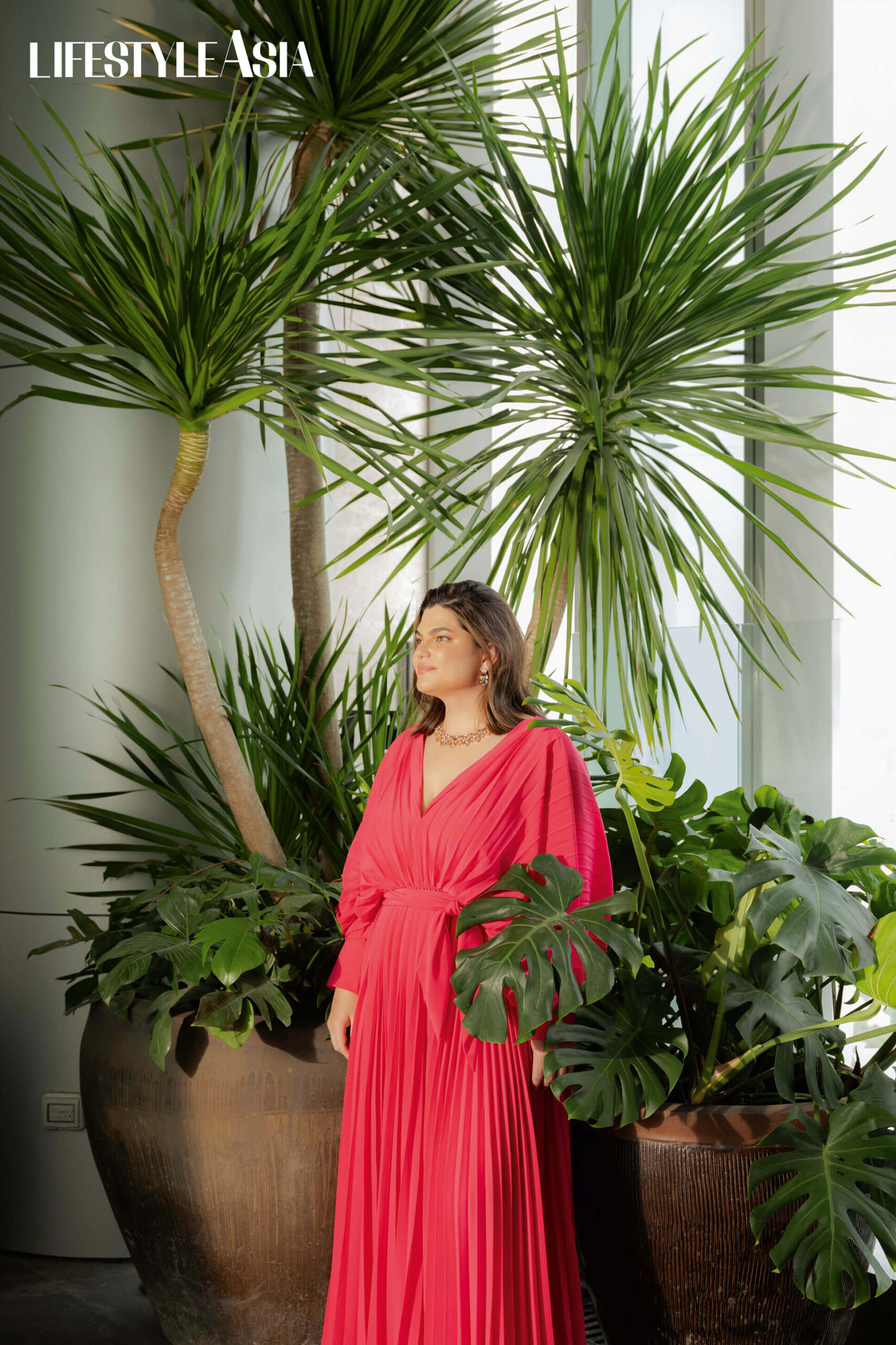 Fuschia pleated dress, HOUSE OF LAUREL; Mixed gemstone earrings and necklace, JJ JIAO JEWELRY.
