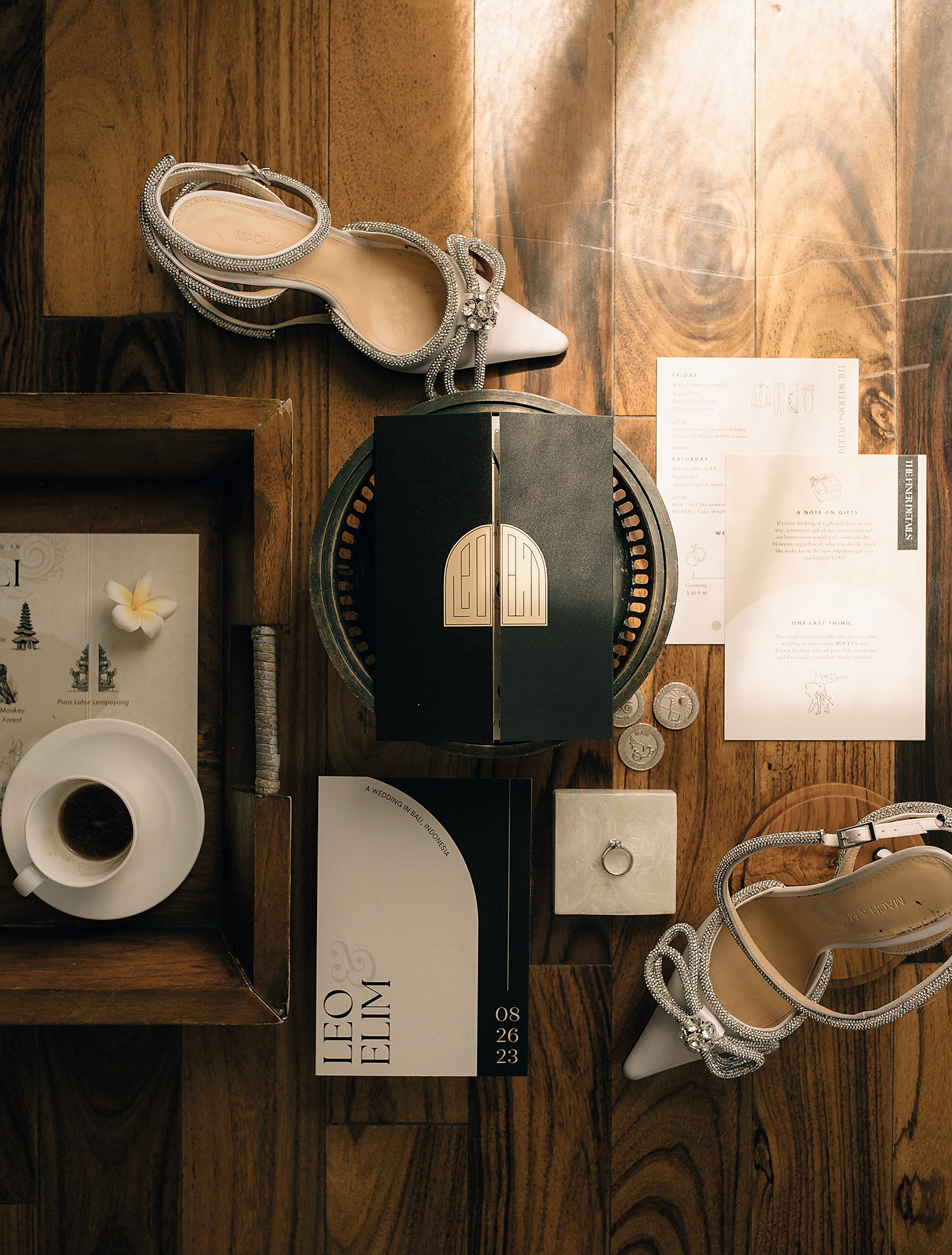 Wedding invitations, ring, and the bride's shoes