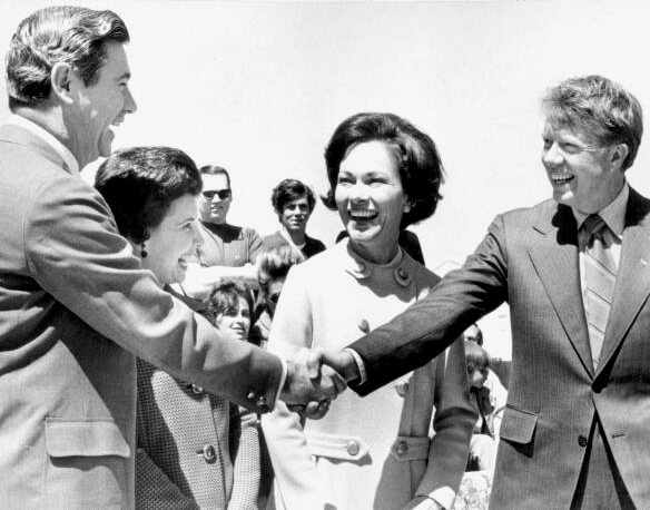 Florida Governor Reubin Askew and his wife (left) welcome Georgia Governor Jimmy Carter and his wife to the reviewing stand to watch the Springtime Tallahassee Parade. Askew and Carter led the parade in the first two cars.