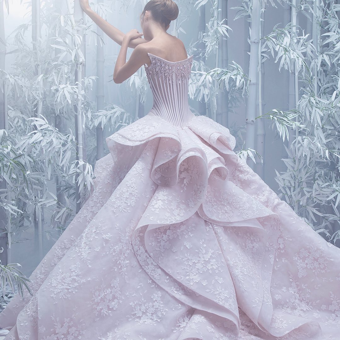 A wedding dress with dramatic layers and embroidered floral patterns