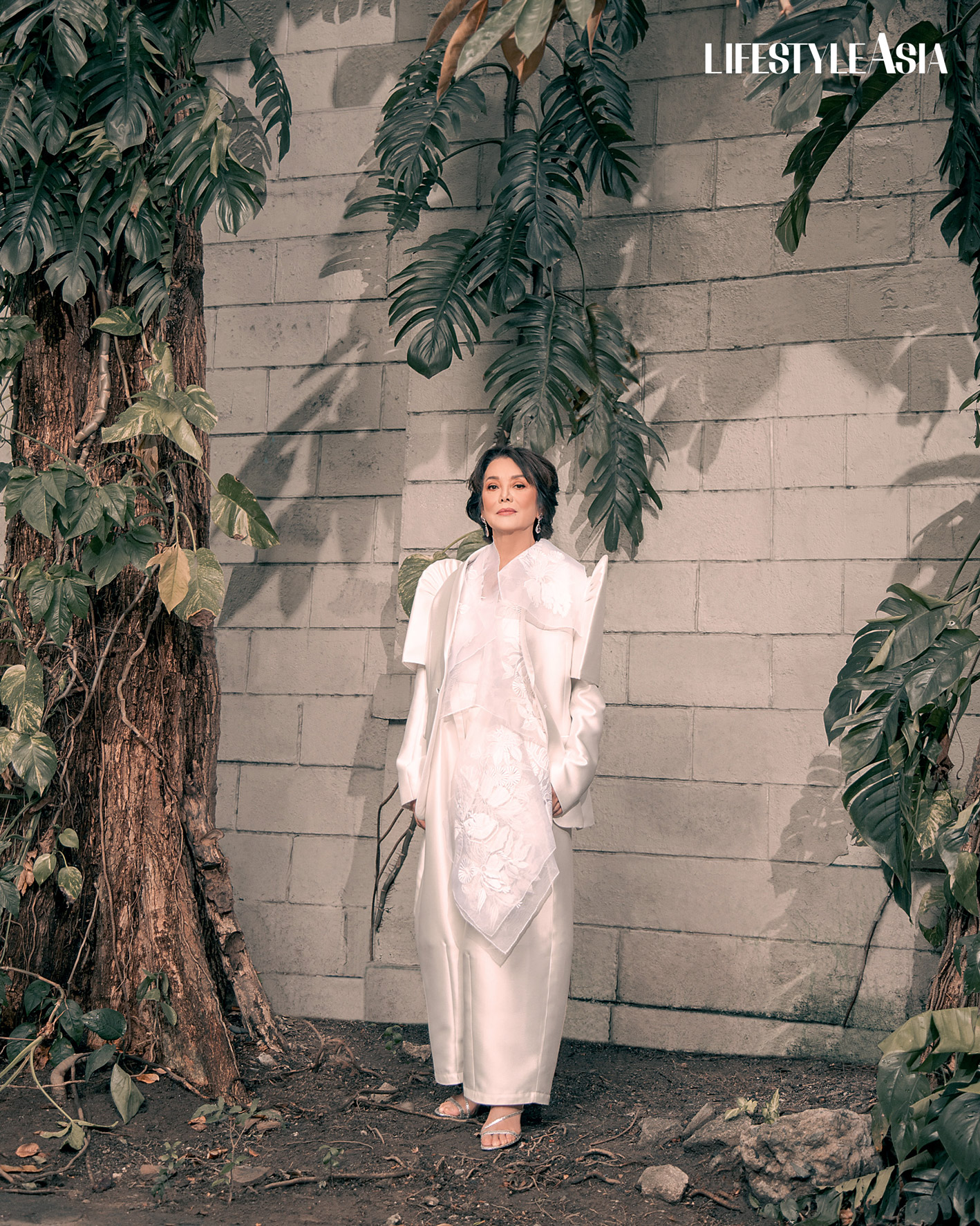 White jusi embroidered vest and mikado satin pants, RAJO LAUREL; Diamond drop earrings, JMA JEWELRY.