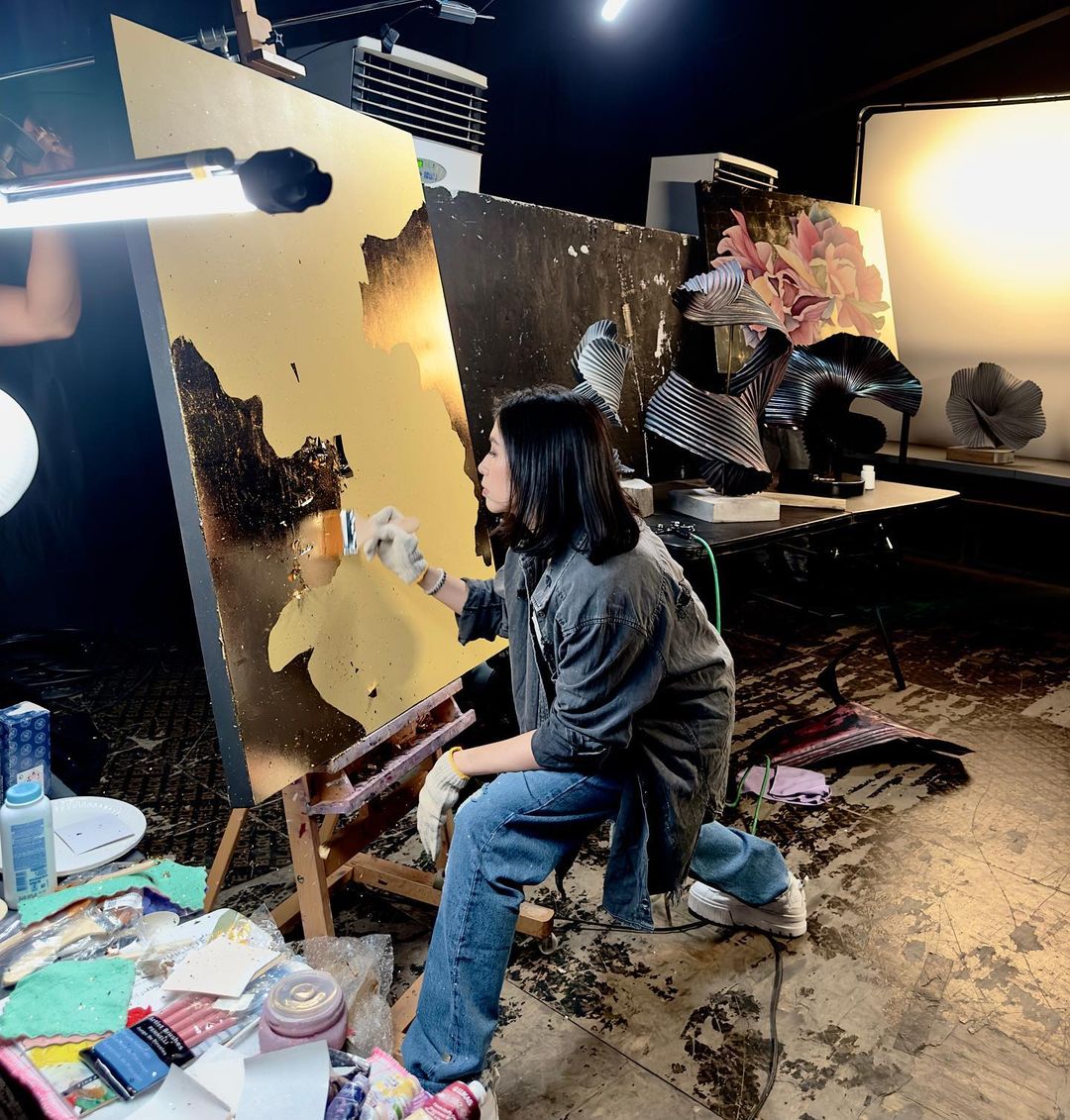 Cuenca working on a gold foil painting