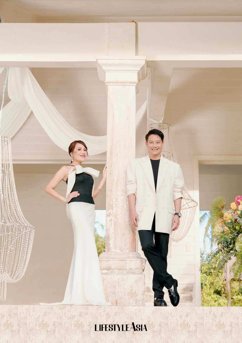 On Aivee: Ivory and black rhinestone encrusted dress, MARK BUMGARNER.
On Z: Ivory oversized double breasted blazer, ANTHONY RAMIREZ; Black tuxedo trousers and shoes, LOUIS VUITTON.