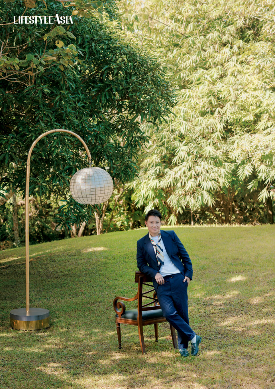 Navy monogram blazer, matching drawstring trousers, scarf and green horsebit loafers, all GUCCI.