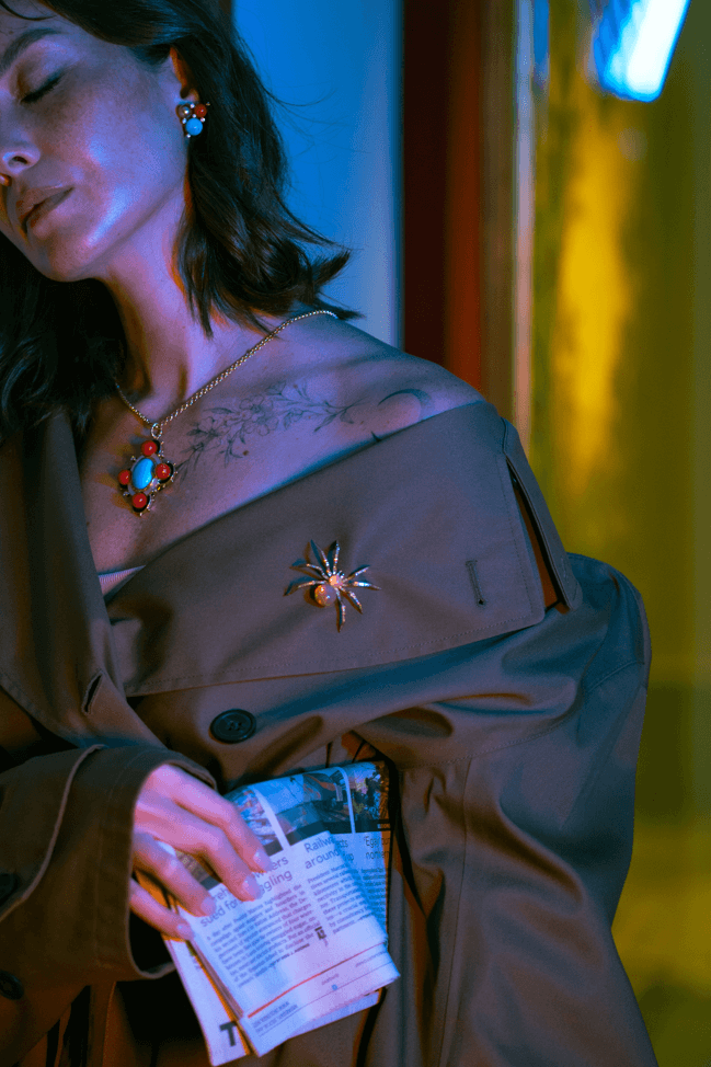 Deco cross of turquoise, onyx, and coral; spider brooch of opals and yellow diamonds; earrings of coral south sea pearl and turquoise.