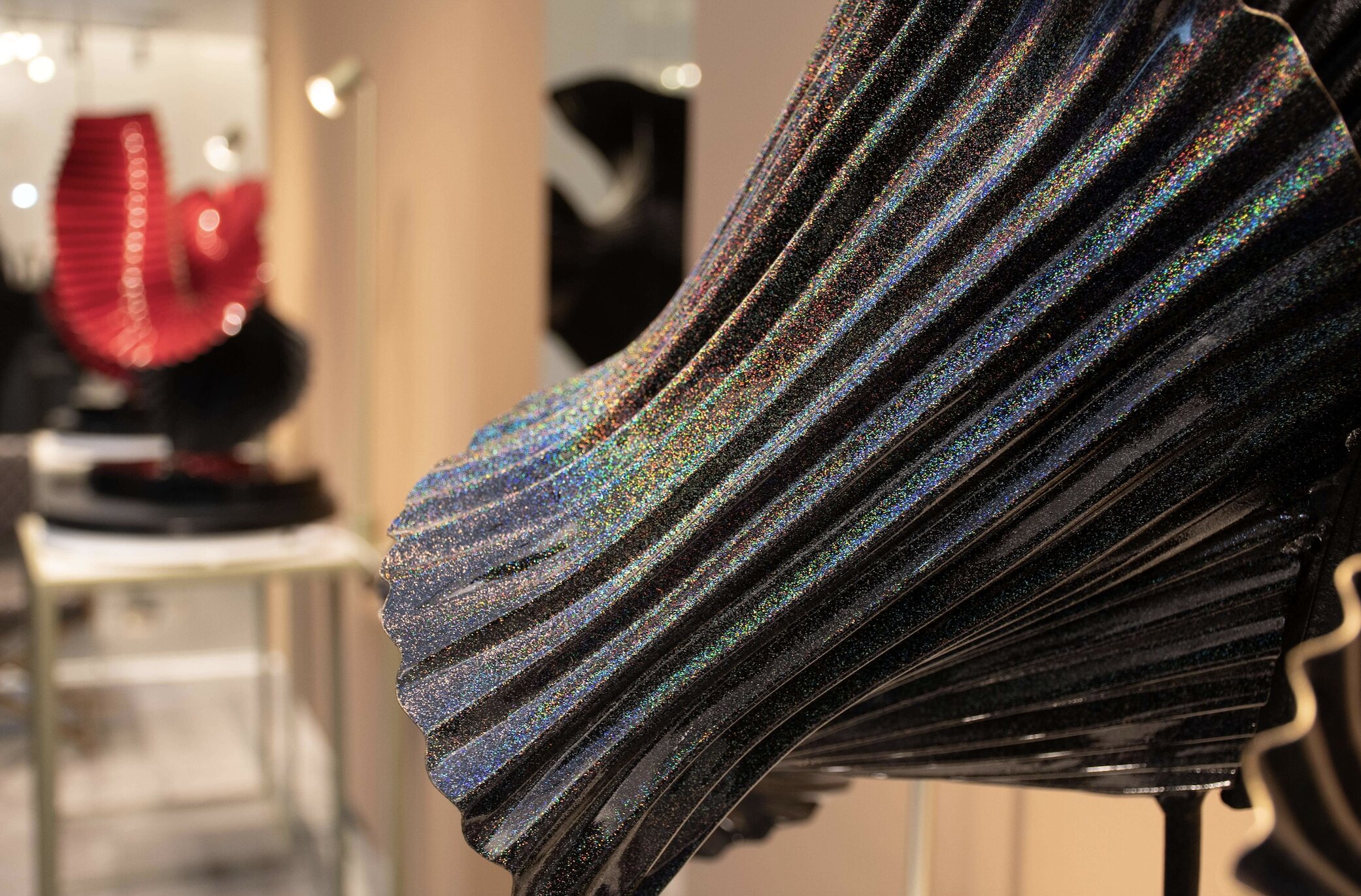 A close-up look at Cuenca's works reveal shimmering paints whose colors shift with the light