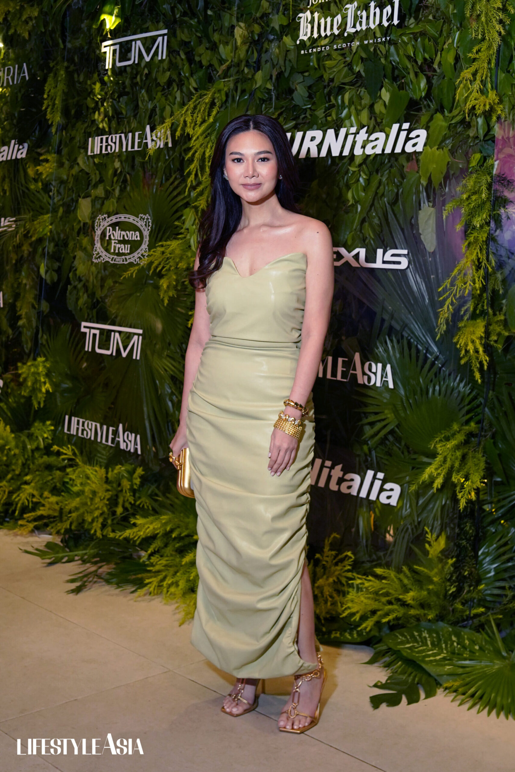 Kai Lim in front of the photo wall of Lifestyle Asia. 