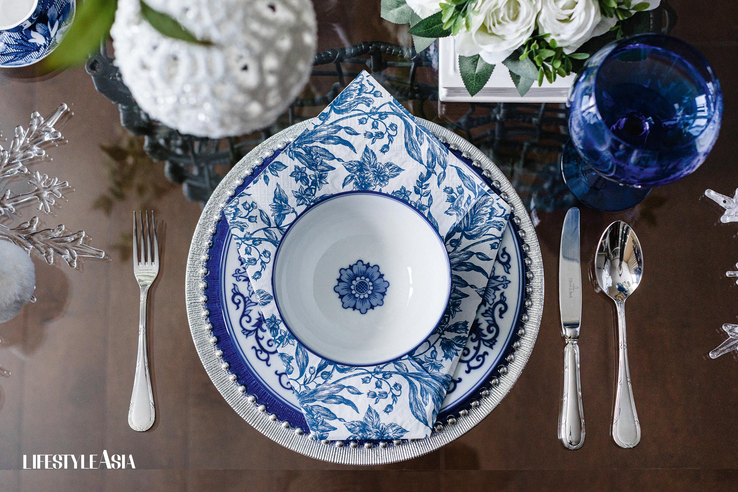 On Cynthia’s festive table, blue charger from Z Gallerie, plates and bowls from Bombay Company in Los Angeles, water goblets from Crate and Barrel, cup and saucer from Zara Home.