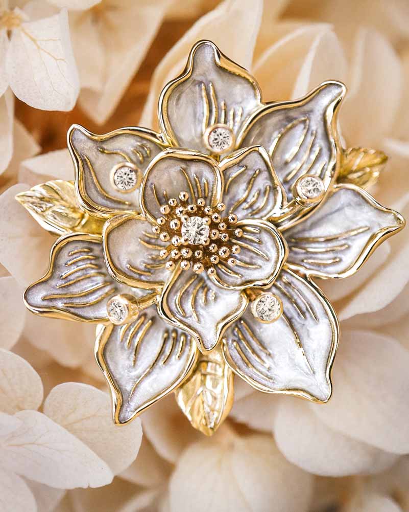 The Sampaguita Brooch with pearl-colored enamel petals and round diamond decors