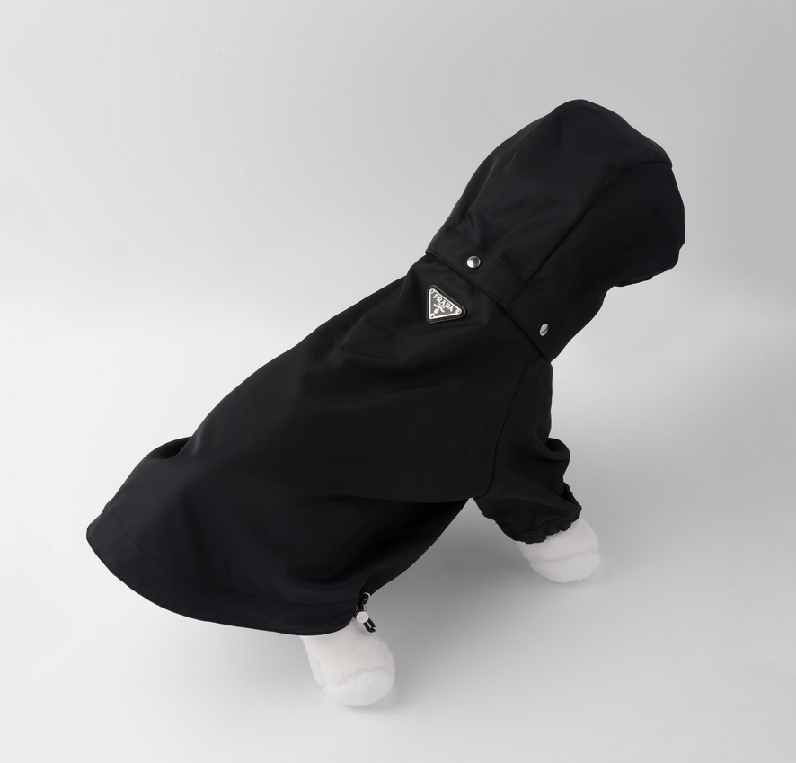 Prada’s metal triangle logo and signature dark fabric on the stylish raincoat