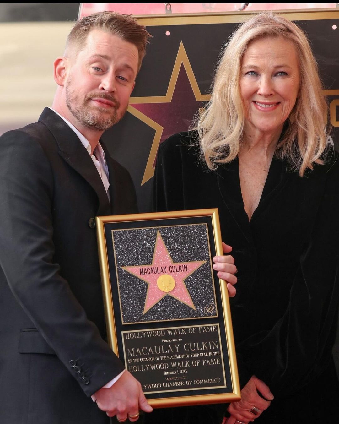 Macaulay Culkin holding his Hollywood walk of fame star with Home Alone mom Catherine O’Hara