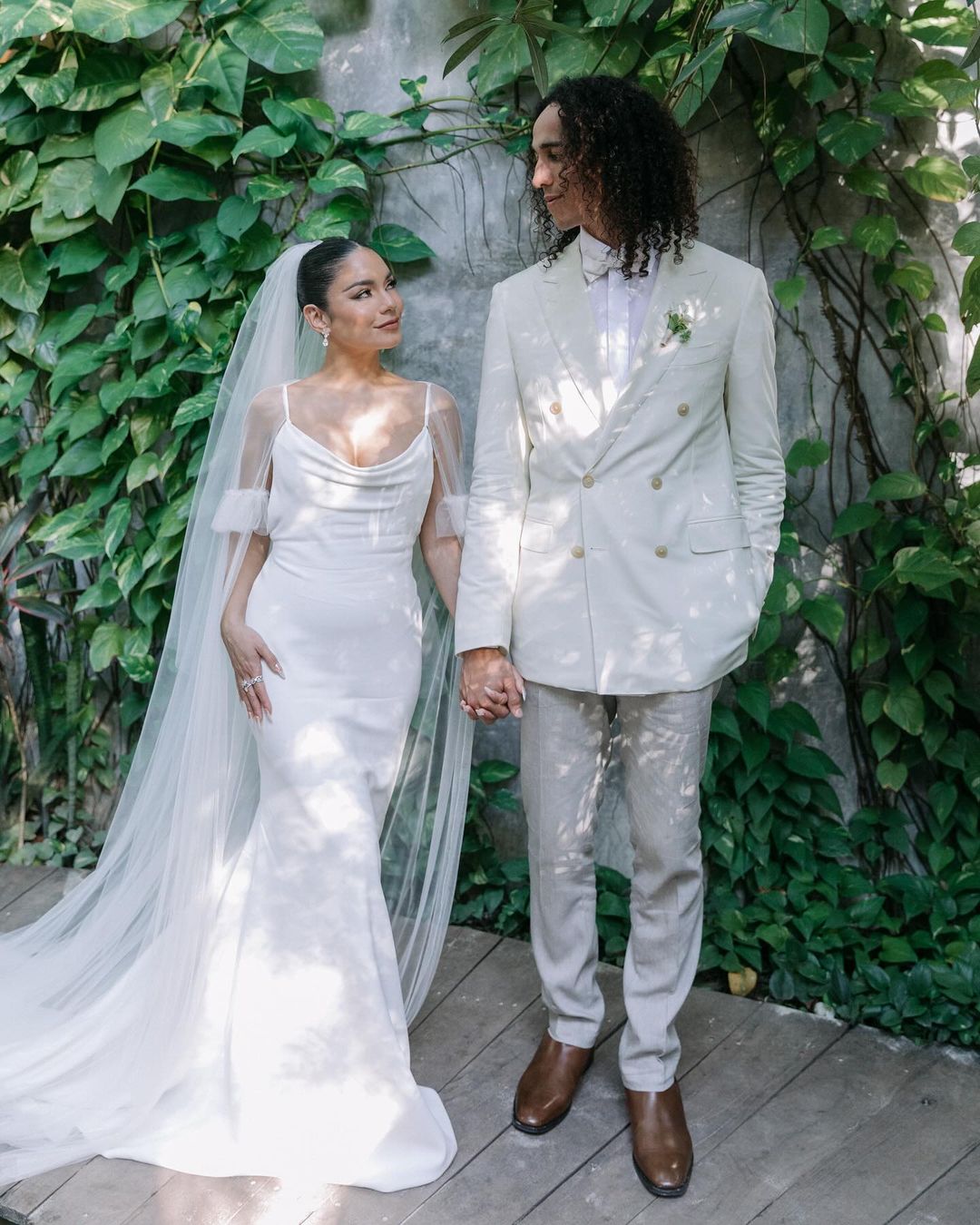 Vanessa Hudgens wearing her ceremony gown from Vera Wang, with Cole Tucker wearing a Me by Canali ensemble