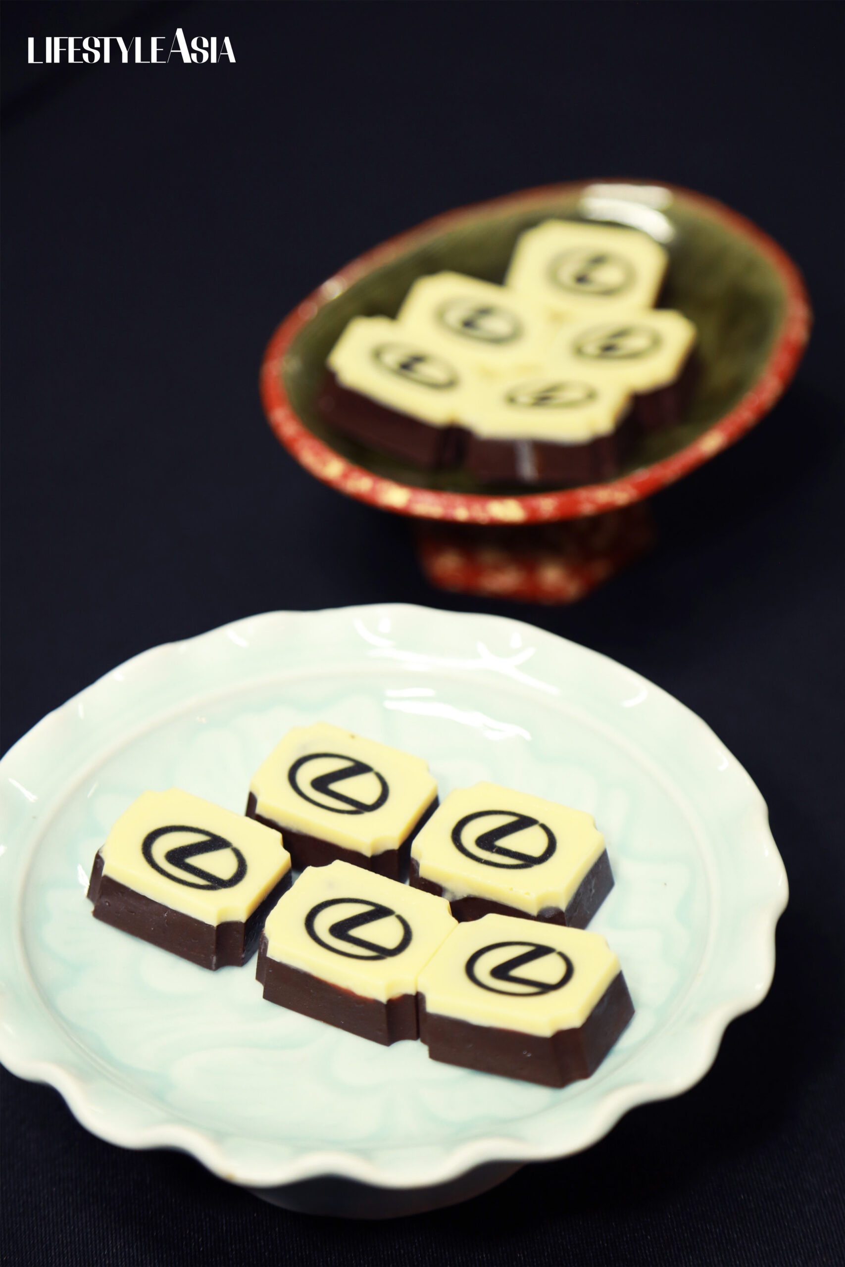Enter the scene-stealer–adorable praline chocolates, each adorned with the letter L, resembling the iconic Lexus logo. 