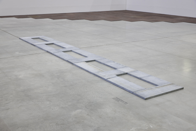 Carl Andre’s “Limestone Pentacel” (16 unit Belgian blue limestone rectangle, 2009)