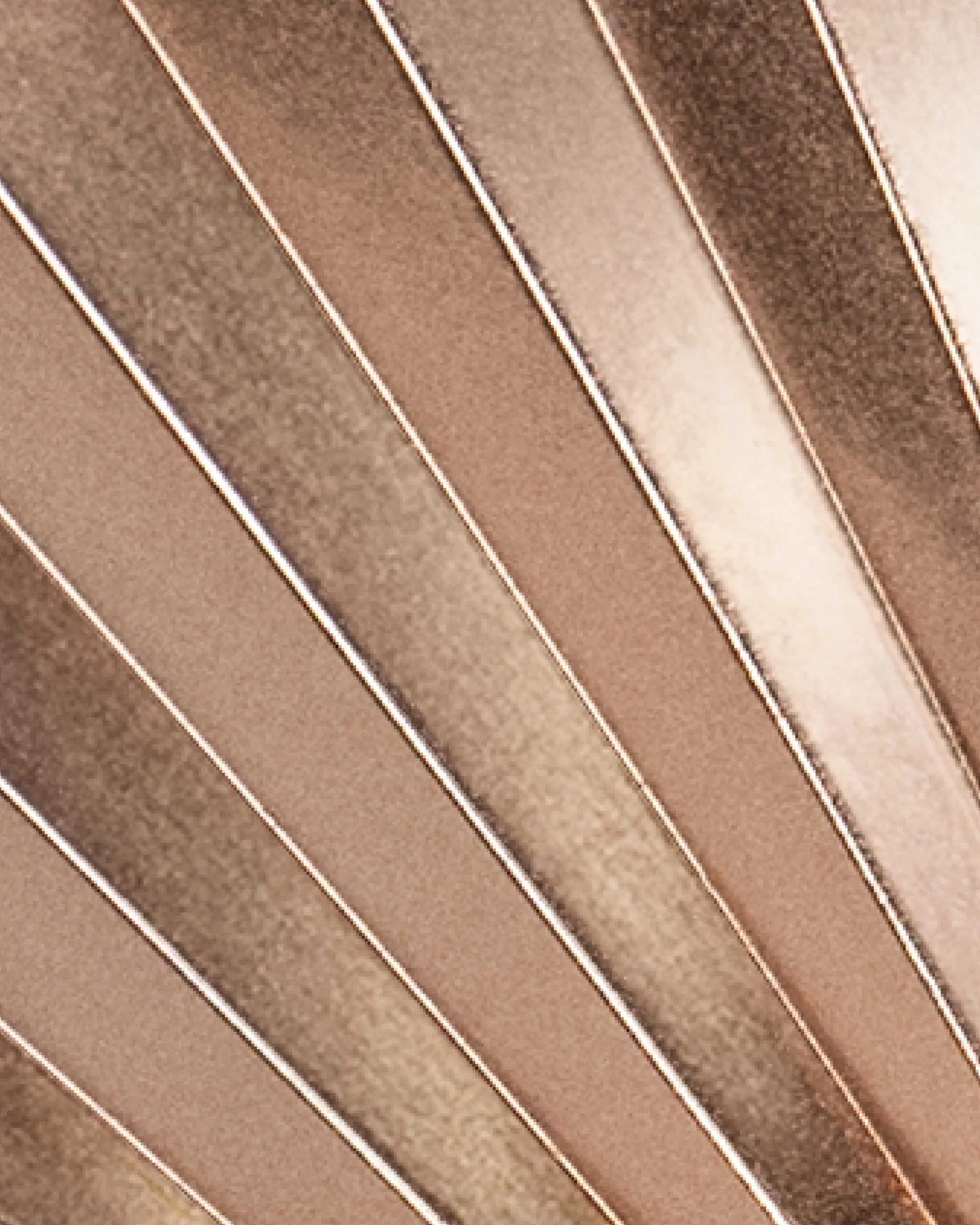 The gold, silver, or bronze pieces of the medals feature lines that represent light rays