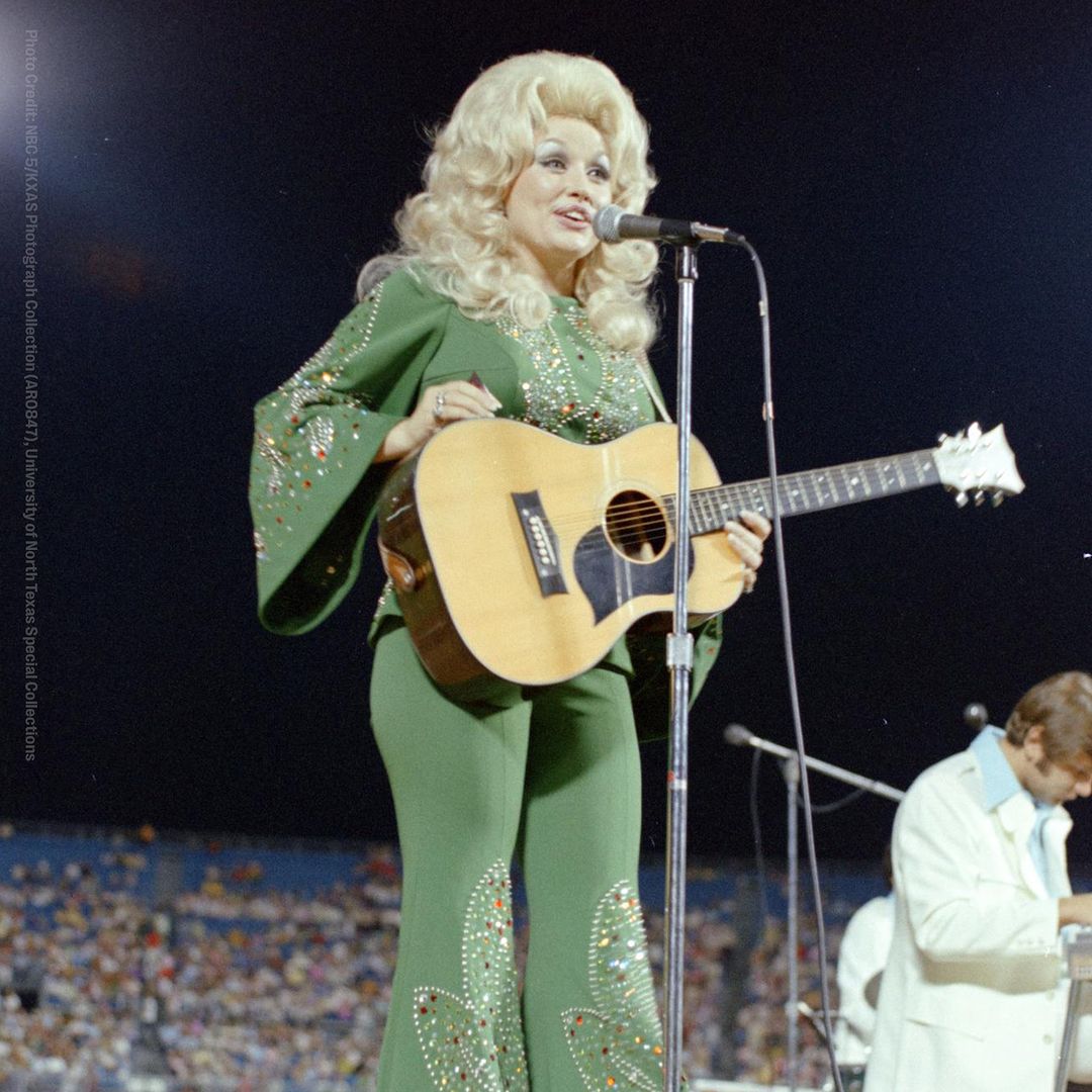 Dolly Parton wearing her jade green outfit, now for auction