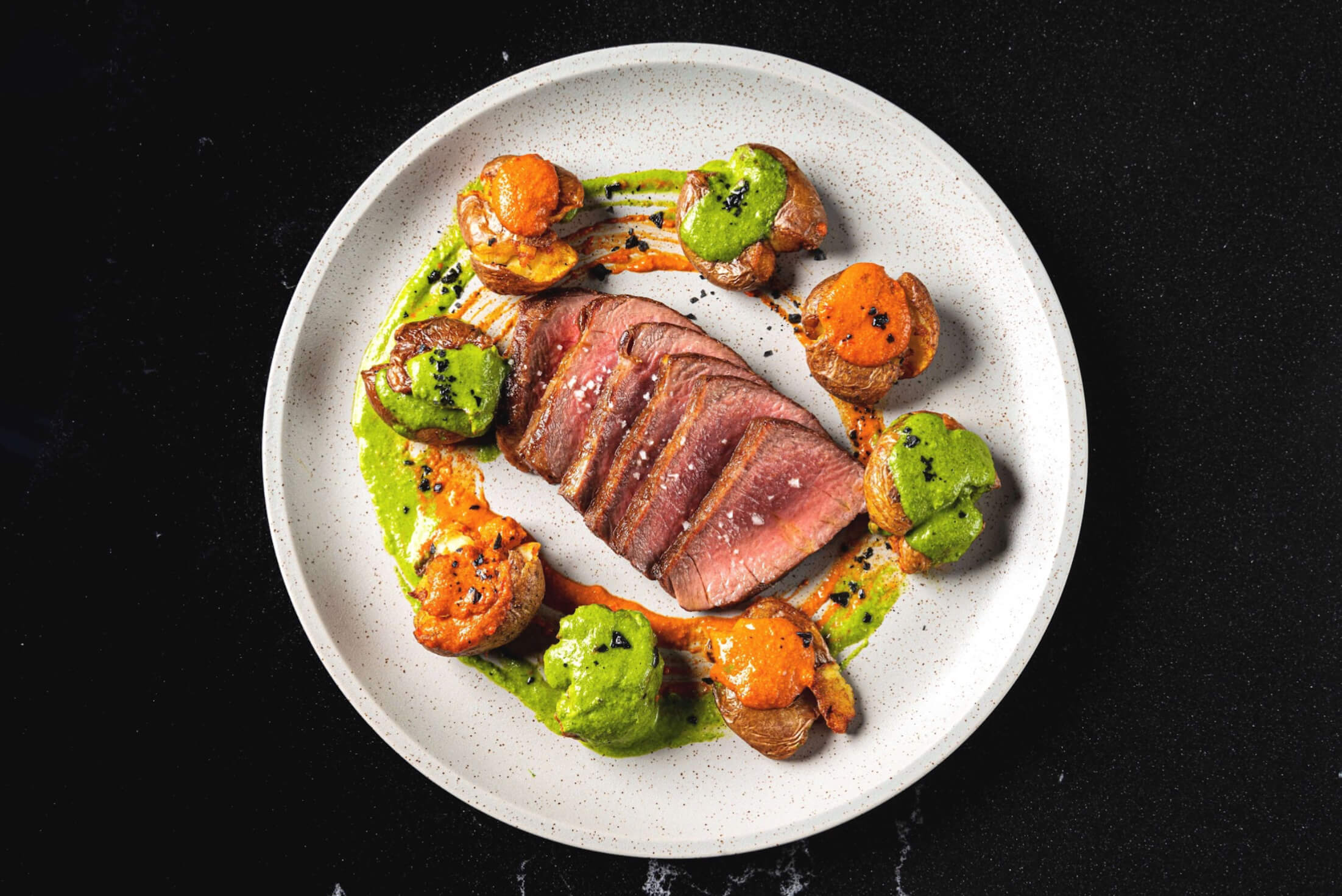 Presa Iberico con Patatas y Mojos (Grilled pork Iberico steak, fried marble potatoes, green and red mojos sauces)