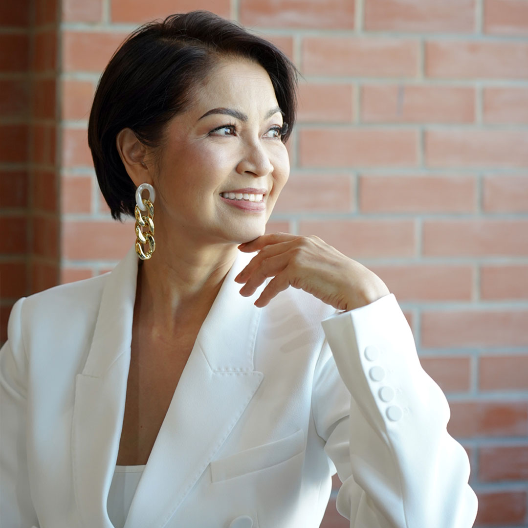 Eloisa Valenton posing for the camera in a white blazer
